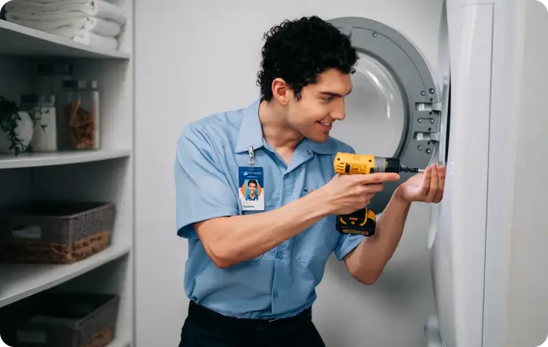 An appliance repair specialist working on a washing machine