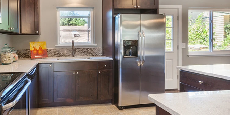 Clean kitchen with refrigerator and oven range