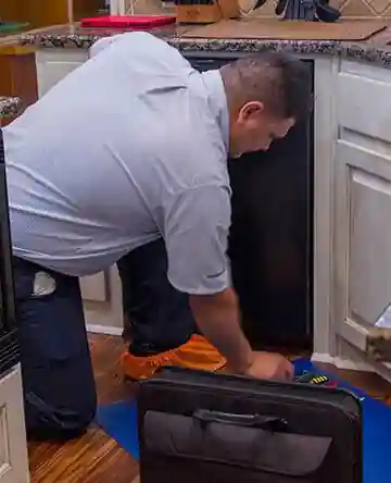 Mr. Appliance repair tech repairing a dishwasher in memphis, tn