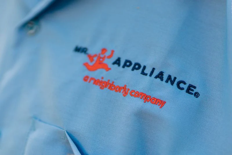 Mr. Appliance logo on shirt.