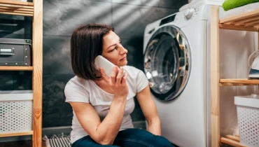Woman on the phone calling for washing machine repair