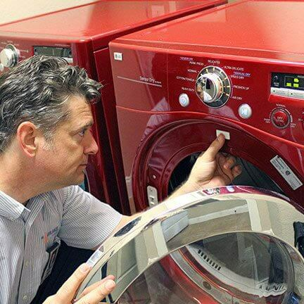 Mr. Appliance technician completing washing machine repair